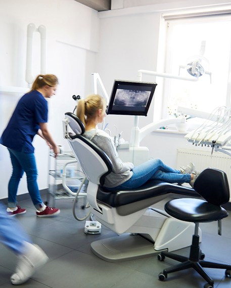 Blurred dentists helping a dental patient
