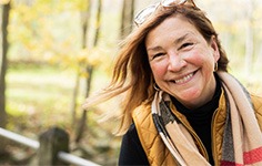 a smiling woman on a walk outside