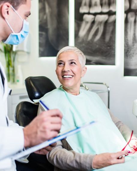 a patient smiling at her dentist