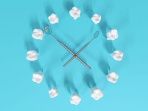 Teeth arranged in a clock with dental mirrors as the hands with a blue background